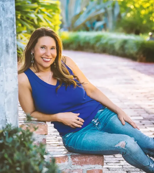 Allison sitting on a garden path